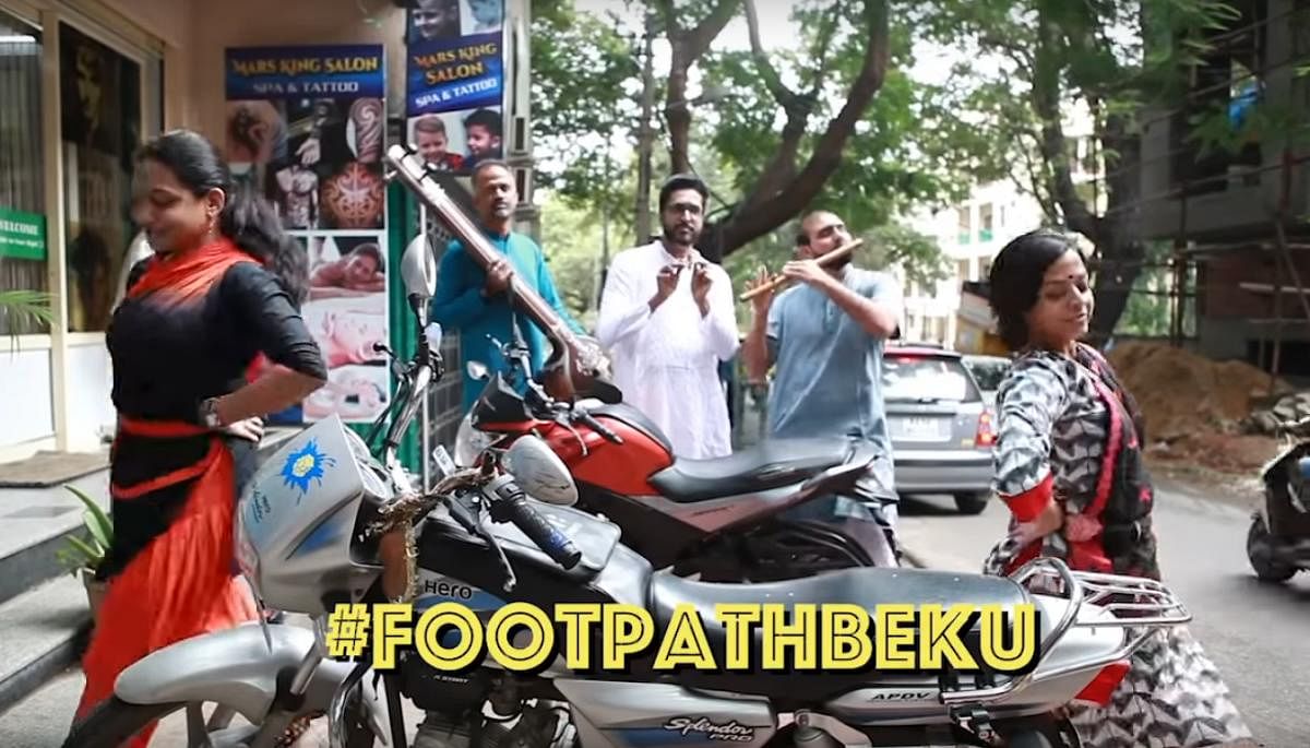 The video points out the sorry state of footpaths in Malleswaram and how the citizens occupy them for their convenience. 