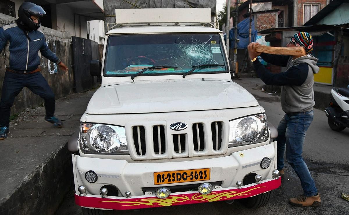 Unidentified activists damage a vehicle during a strike called by All Assam Students’ Union and the North East Students’ Organisation in protest against Citizenship (Amendment) Bill, 2016, in Guwahati, on Tuesday. PTI