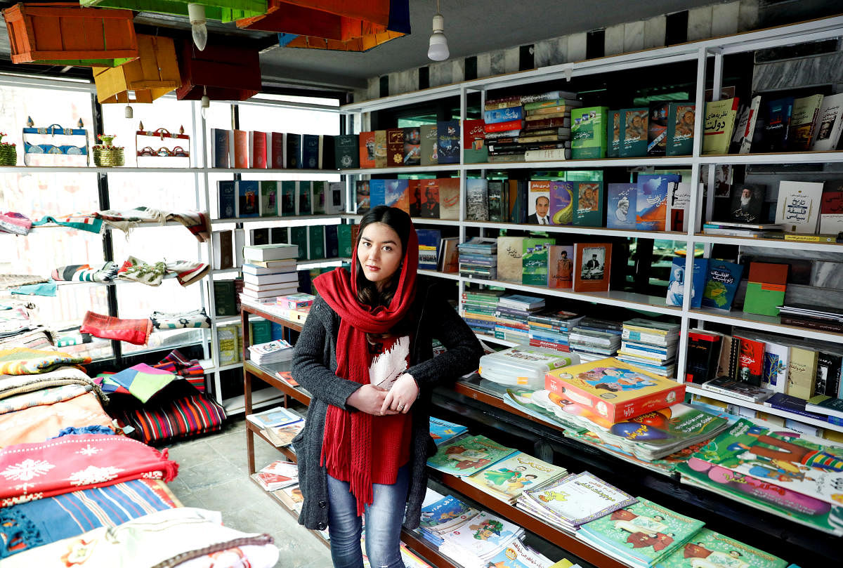 Zarghona Haidari, 22, who works at a book store in Shahr Ketab Centre, poses for a picture in Kabul. (REUTERS)