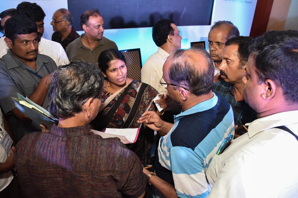 Citizens interact with Mayor Gangambike Millikarjun at the event. 
