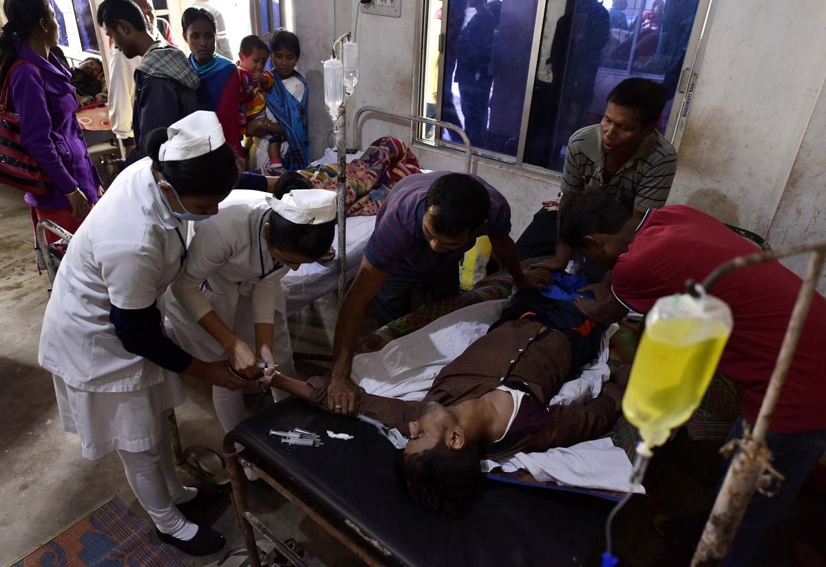 File photo of the recent hooch tragedy victim being treated at a hospital in Golaghat district. AFP