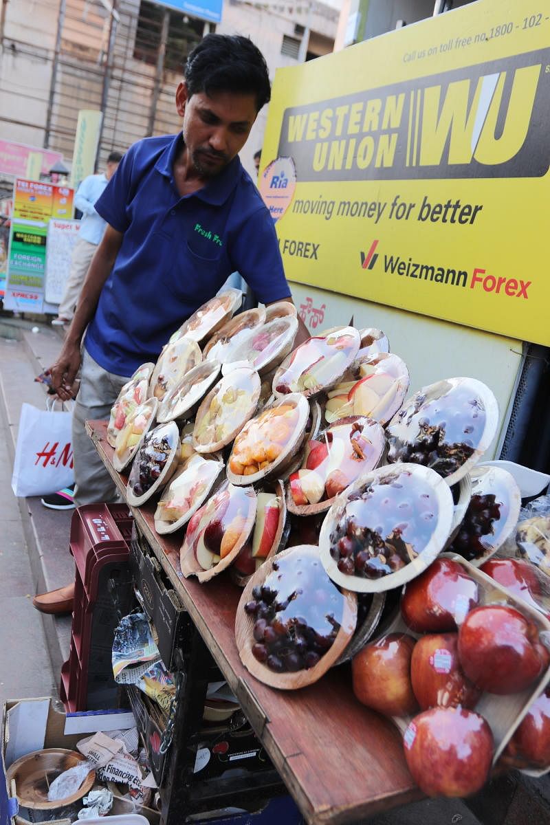 Fruit seller Amjad on Brigade Road makes sure his food is tightly wrapped in plastic. 