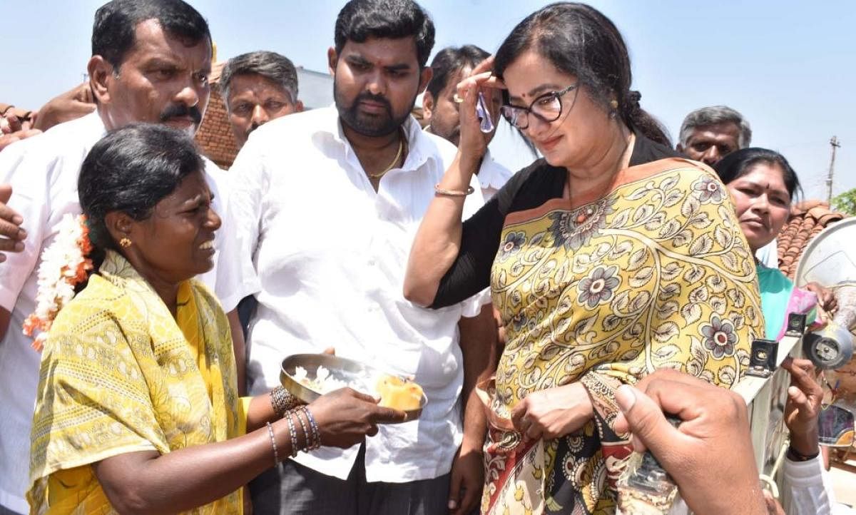 A woman offers a traditional welcome to Sumalatha Ambareesh at Bevinahalli in Mandya district, recently. The multilingual actor has announced that she would contest from Mandya as Independent if the Congress deny ticket.