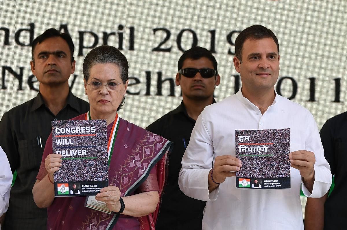 Congress president Rahul Gandhi (R) and the party's former president Sonia Gandhi (L) pose with copies of their party election manifesto in New Delhi. AFP