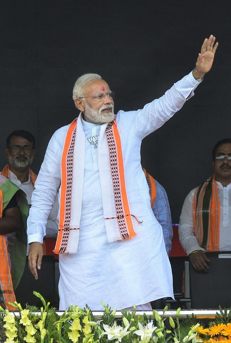 Prime Minister Narendra Modi waves at the crowd during an election campaign rally for Lok Sabha polls, in Udaipur, Tripura. PTI