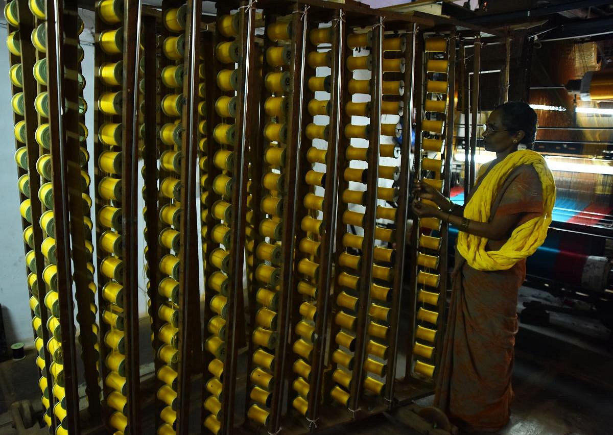 Talent and charm Handloom weavers weaving sarees in a pit loom in the Dharwad-Hubbali districts.