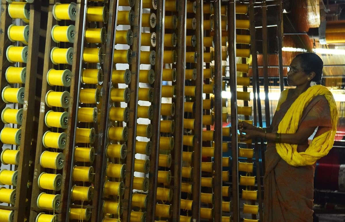 Talent and charm Handloom weavers weaving sarees in a pit loom in the Dharwad-Hubbali districts.