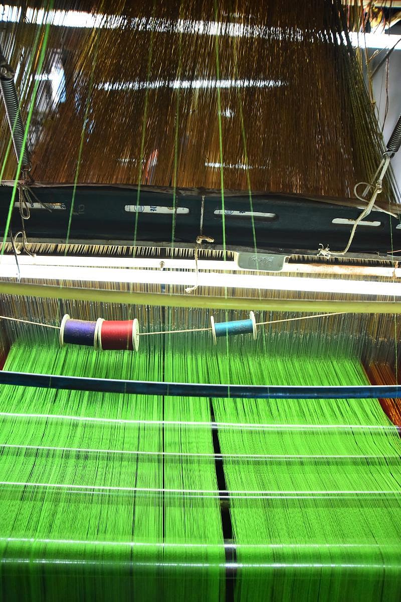 Talent and charm Handloom weavers weaving sarees in a pit loom in the Dharwad-Hubbali districts.
