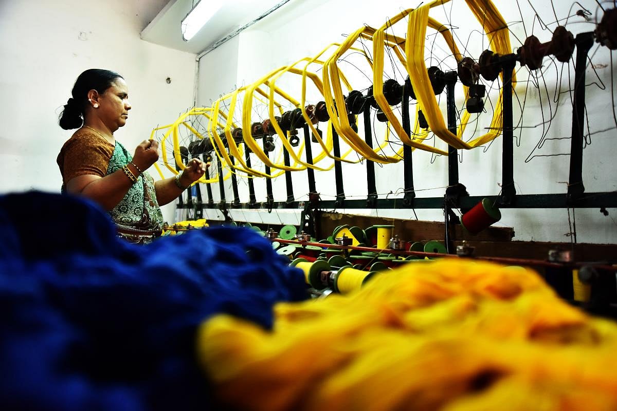 Talent and charm Handloom weavers weaving sarees in a pit loom in the Dharwad-Hubbali districts.