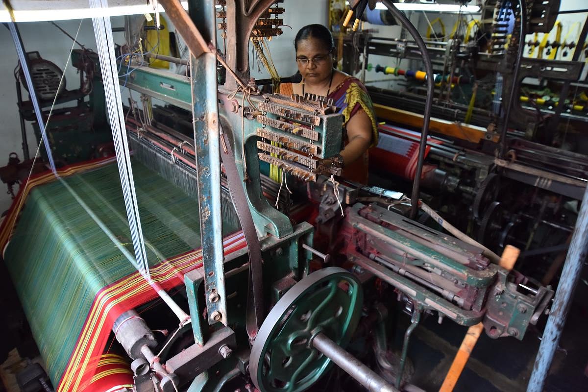 Talent and charm Handloom weavers weaving sarees in a pit loom in the Dharwad-Hubbali districts.