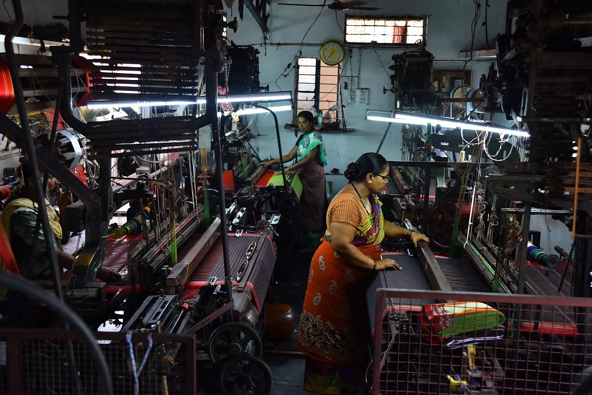Talent and charm Handloom weavers weaving sarees in a pit loom in the Dharwad-Hubbali districts.