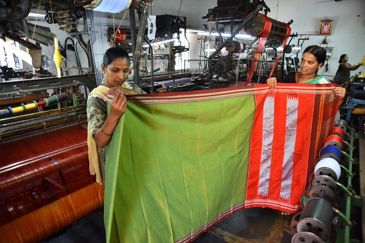 Talent and charm Handloom weavers weaving sarees in a pit loom in the Dharwad-Hubbali districts.