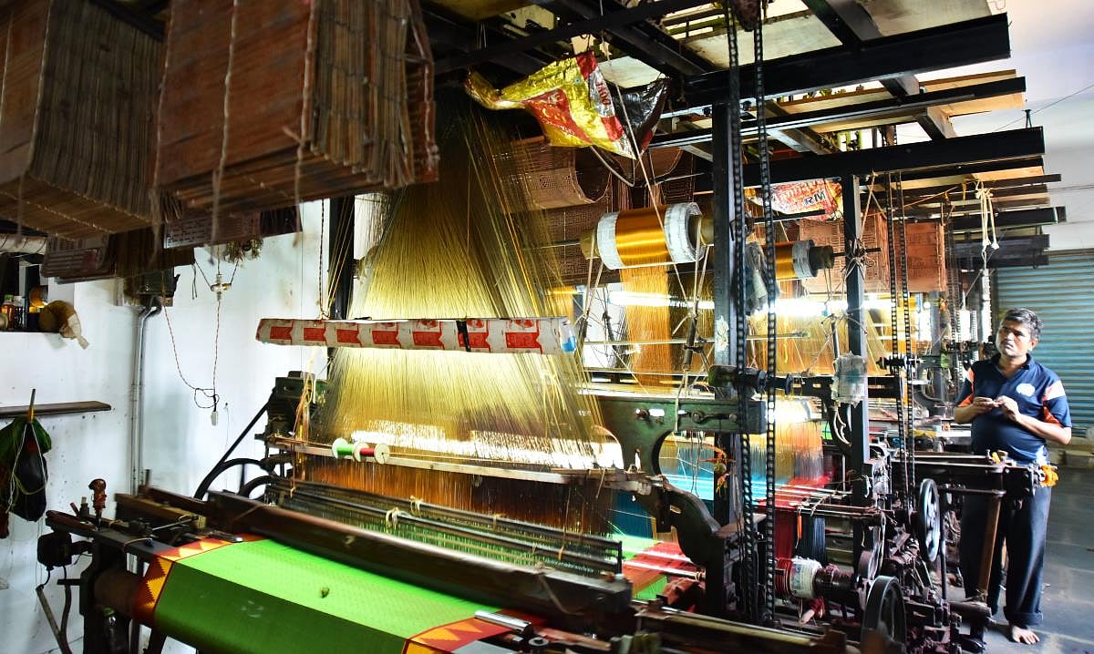 Talent and charm Handloom weavers weaving sarees in a pit loom in the Dharwad-Hubbali districts.