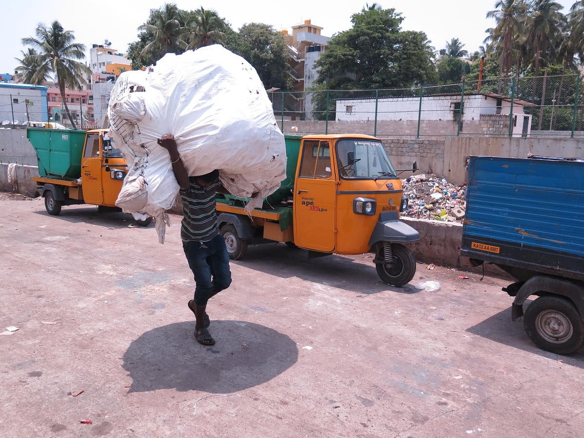 A BBMP worker hauls a bag of garbage at a BBMP waste collection centre in Basavangudi, Bengaluru, on May 9, 2019.