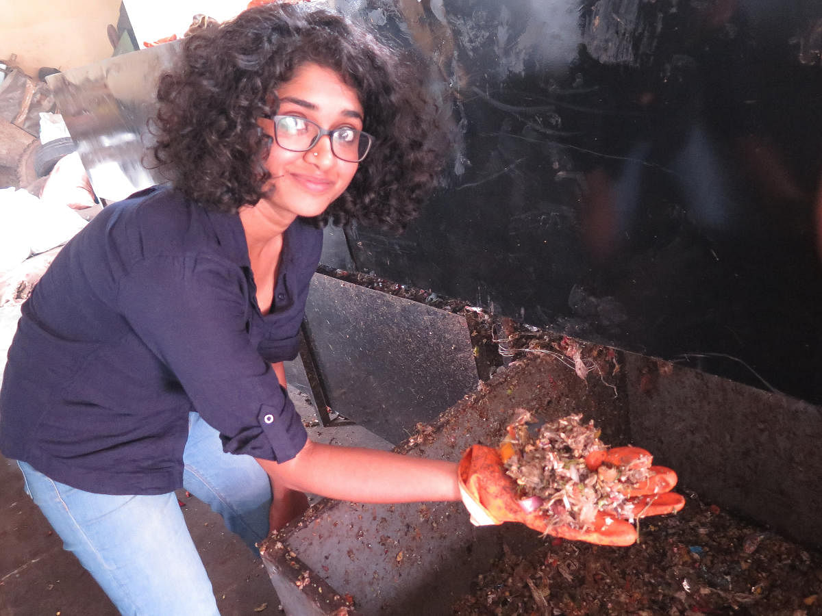 Aishwarya K, Operations Manager for TrashCon, shows biodegradable waste separated from plastics by her company's waste segregation machine at a BBMP waste collection centre in Basavangudi, Bengaluru, on May 9, 2019.