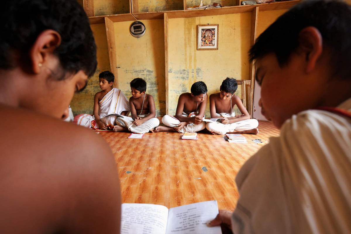 A view of the Sanskrit teacher with his pupil at Anandashram in Melukote; pupil reading Vedas. Photos by Abhishek Chinnappa