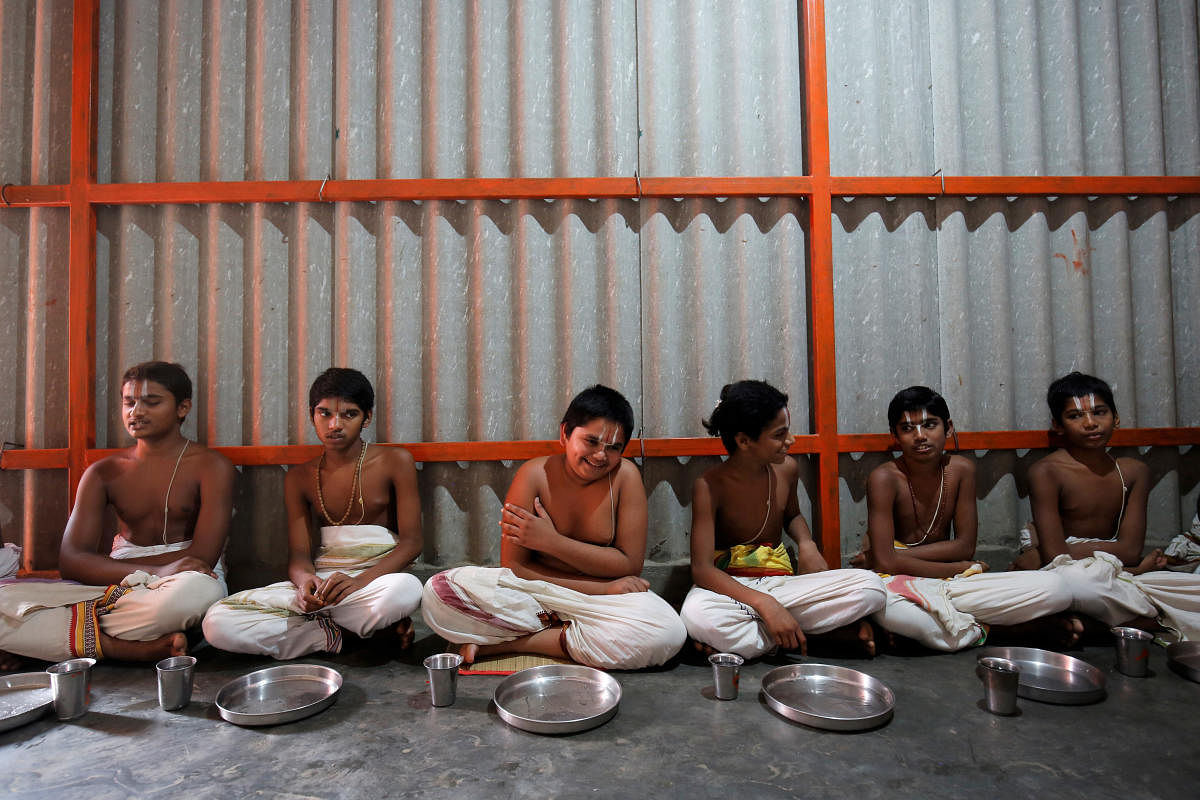 A view of the Sanskrit teacher with his pupil at Anandashram in Melukote; pupil reading Vedas. Photos by Abhishek Chinnappa