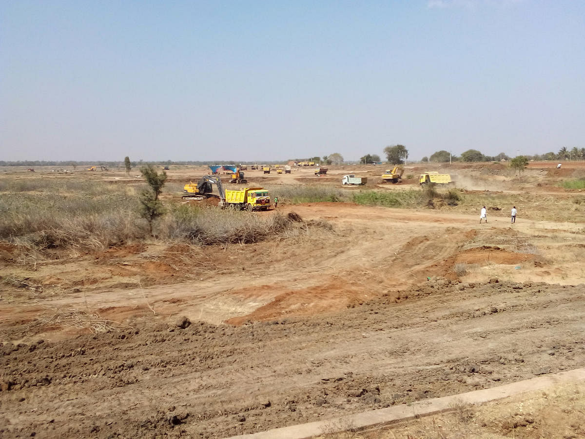 Progressing Revival work is underway at the Nidashesi lake near Kushtagi town in Koppal; villagers gathered for the project inauguration ceremony; a view of the parched lake; earth-moving machines in the desilting process.