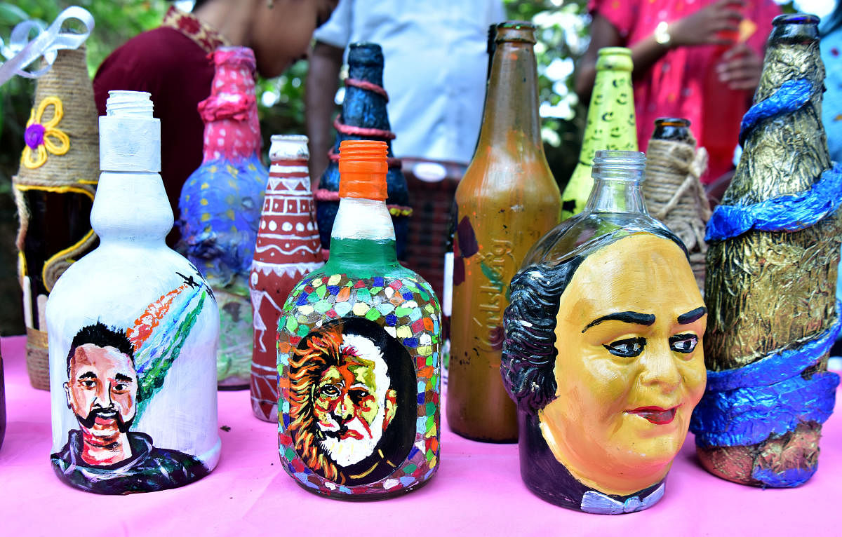 Elegant Open air Bottle Art exhibition-cum-sale organised at Mendon's backyard on the banks of Palguni river in Bokkapatna; bottles with pictures of Abhinandan and Narendra Modi. Photos by Govindraj Javali