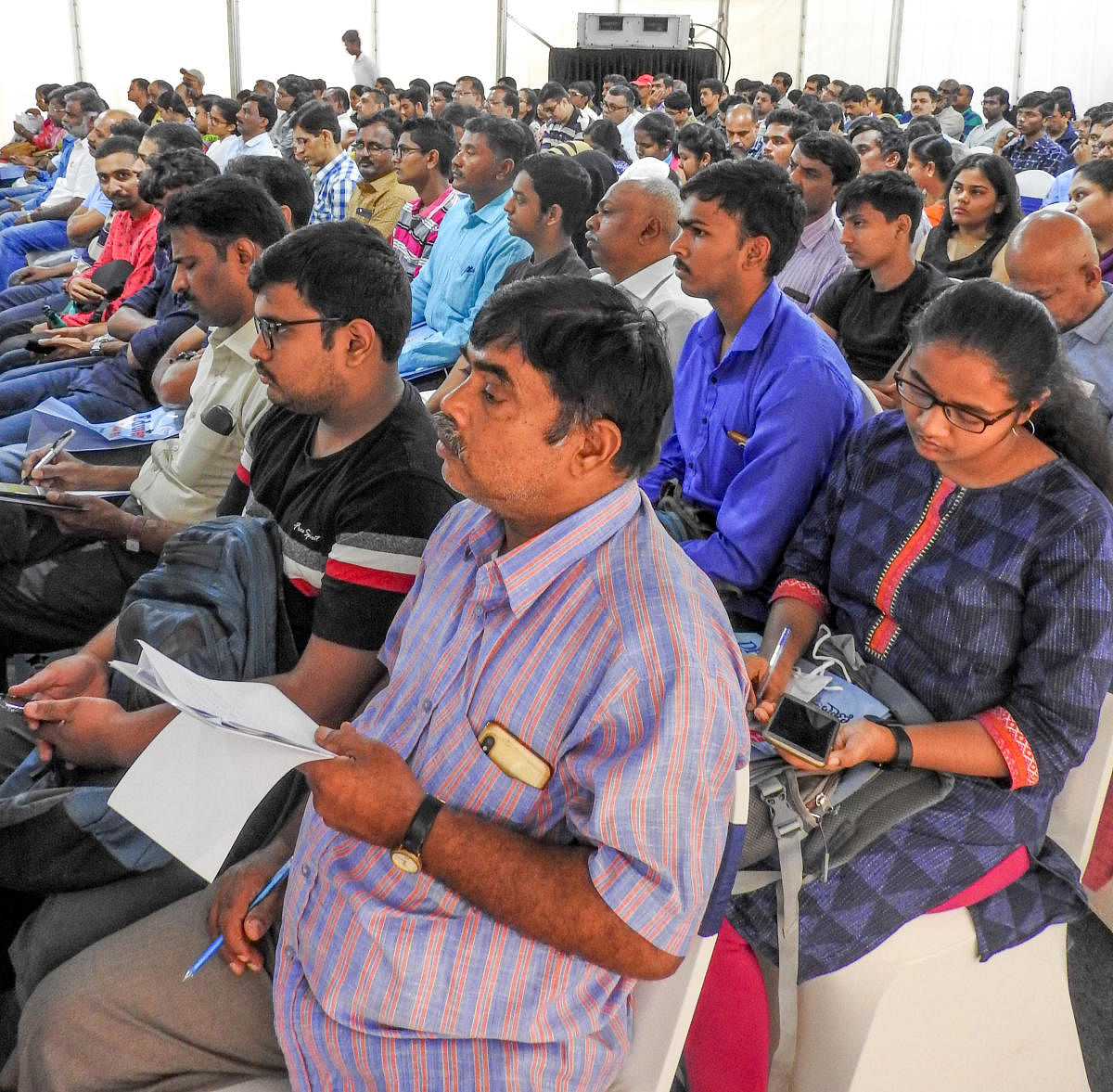 Parents and students note down guidance provided by experts at the 11th edition of Eduverse-Jnanadegula annual education fair organised by Deccan Herald and Prajavani in the city on Sunday. DH photo/Srilekha R