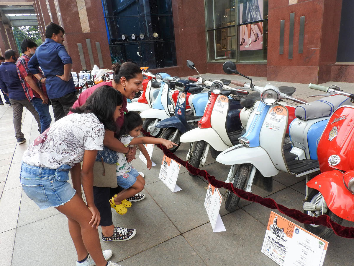 A family appreciates the beauty of vintage bikes at the exhibition on Saturday. DH PHOTO/SRILEKHA R