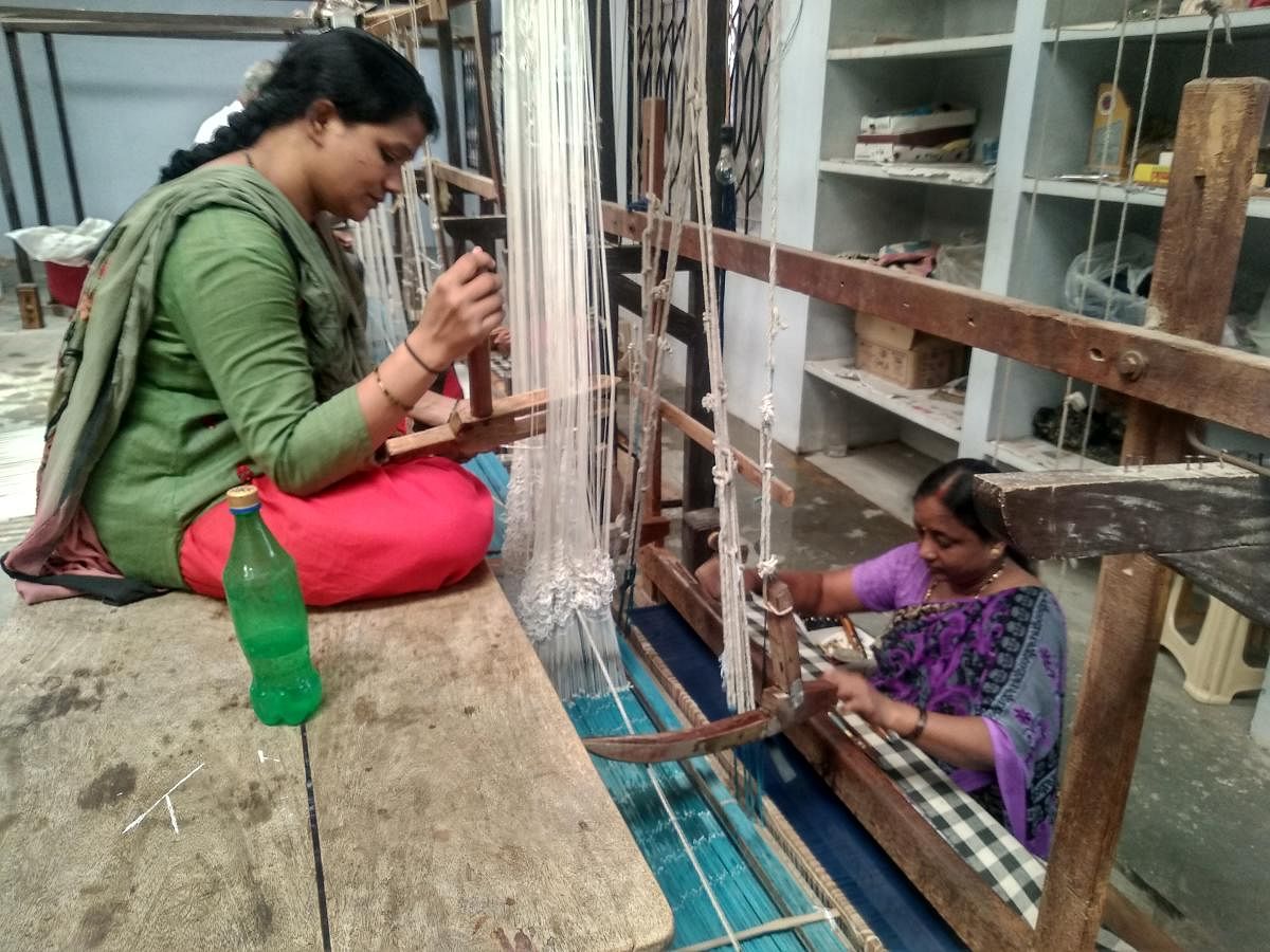 Women at her weaving unit. 