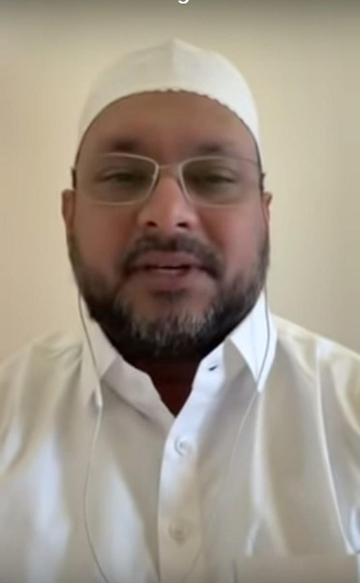 A screenshot of IMA Group founder Mohammed Mansoor Khan speaking in a video. 