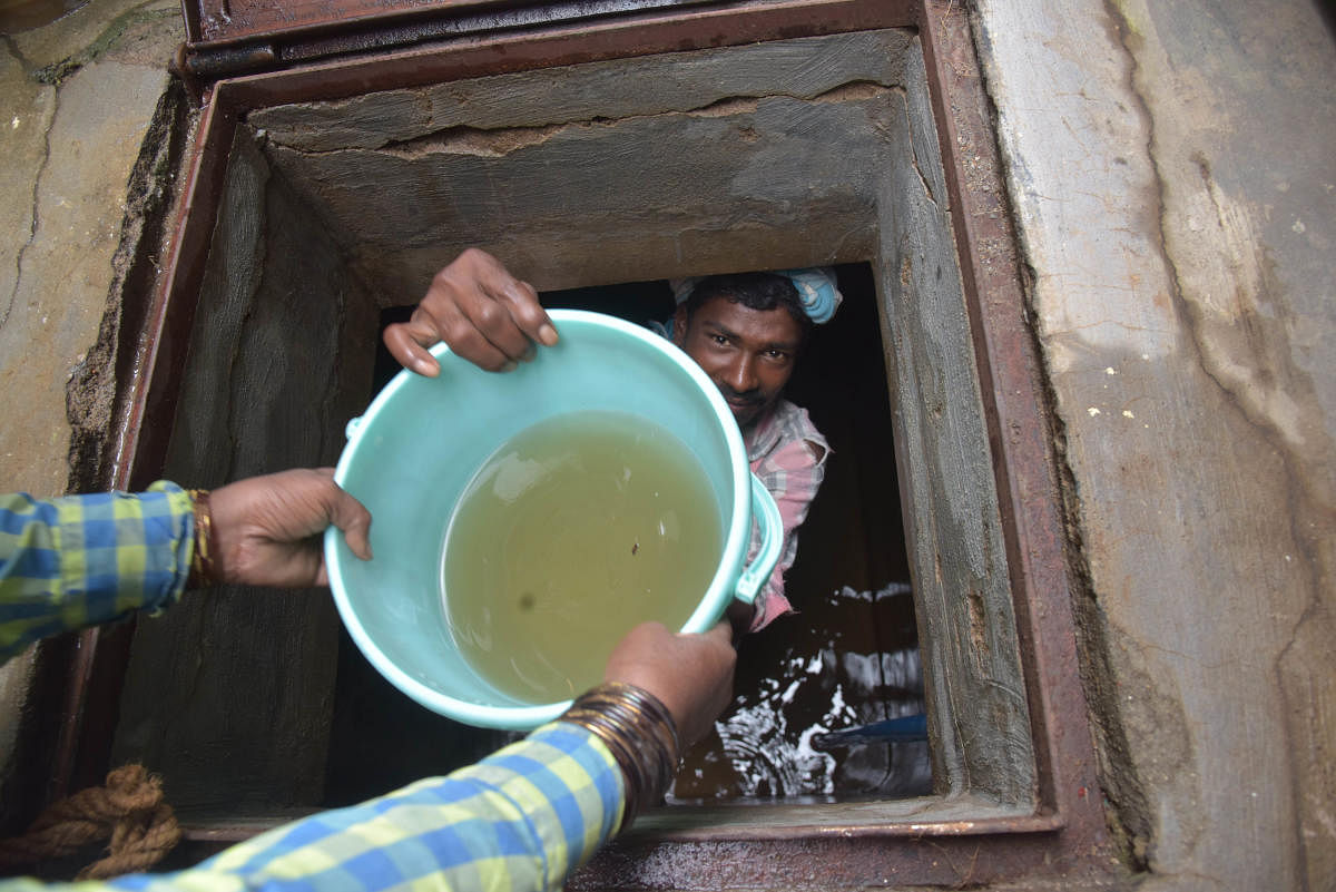 A worker draining out a sump filled with contaminated water at HBR Layout in Bengaluru on Wednesday. DH Photo/BH Shivakumar