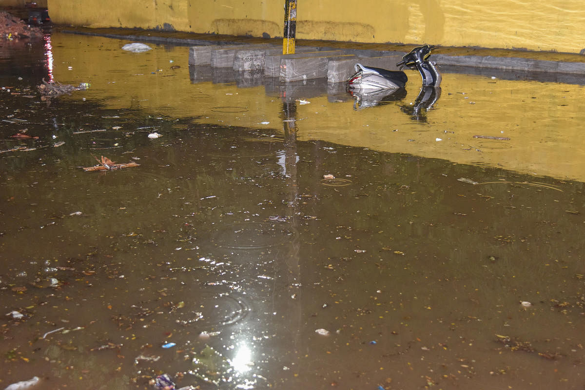 A two-wheeler stuck on an inundated BTS Road, Wilson Garden, in Bengaluru on Wednesday night. DH PHOTO/S K DINESH