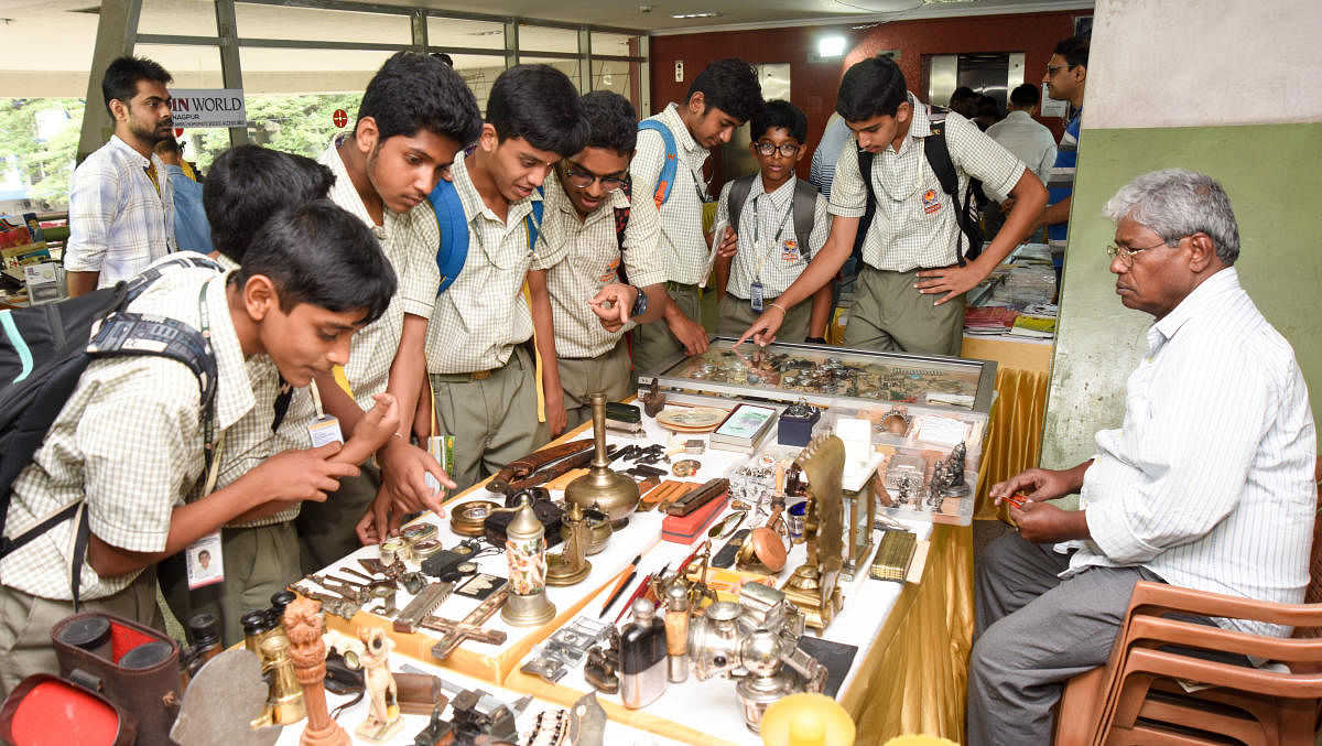 Glimpse of the past: Students viewing coins and other artefacts displayed at an exhibition at Karnataka Numismatic Society in Bengaluru. DH Photos/ Anup R Thippeswamy