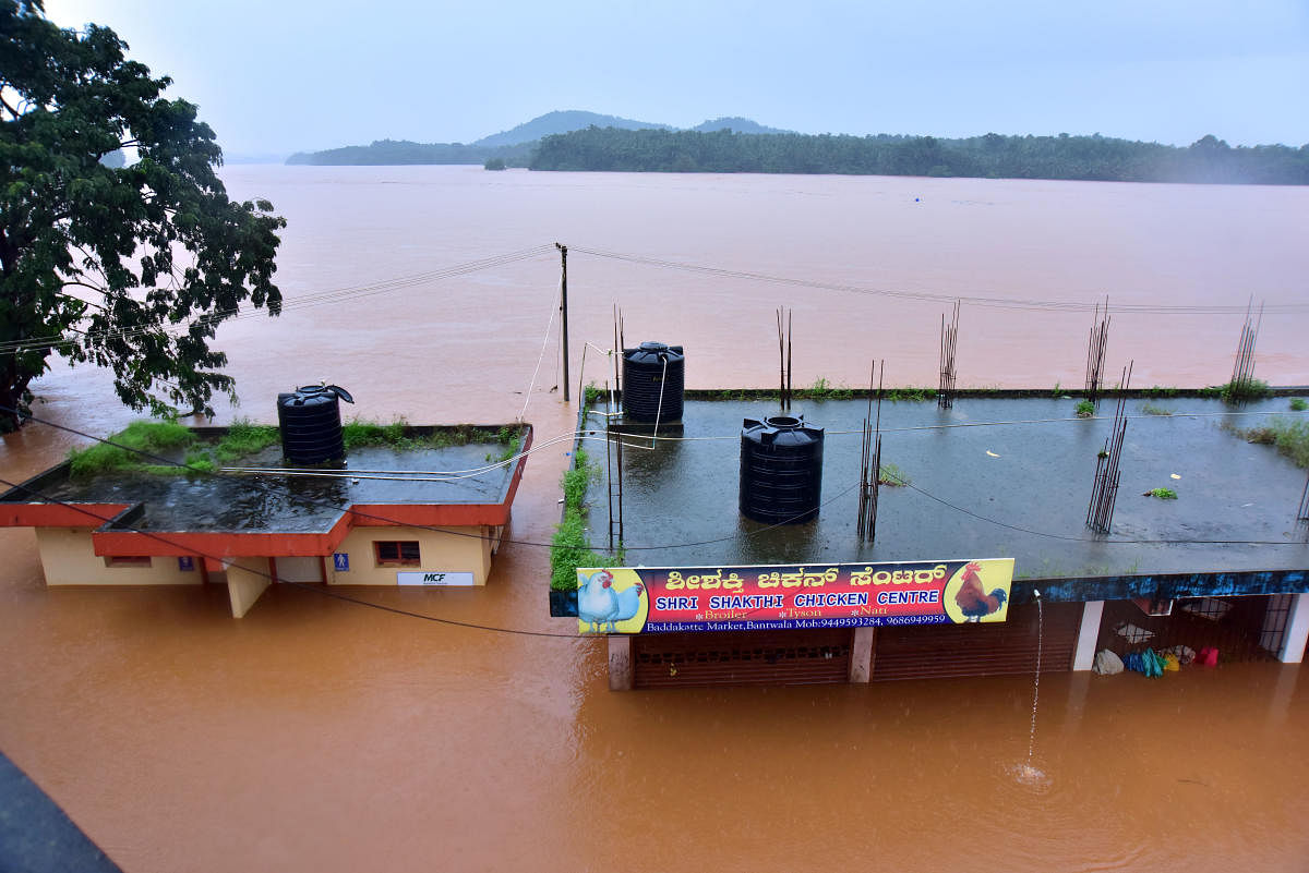 The Baddakatte market near B C Road submerged by Netravathy river in spate on Saturday.