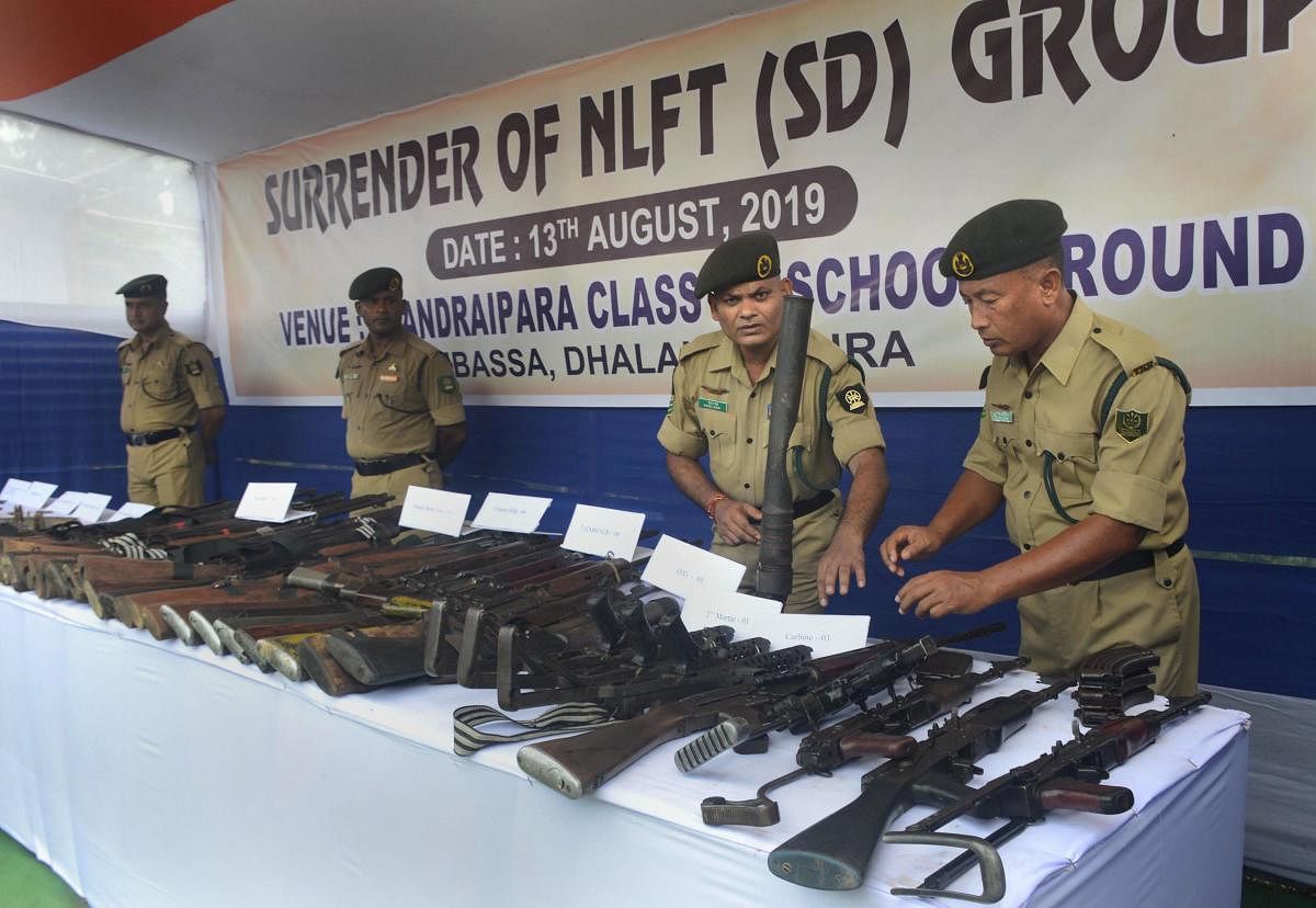 Tipura State Rifles personnel display the weapons of surrendered by National Liberation Front of Tripura (SD) cadres, at Ambassa on the outskirts of Agartala on Tuesday. PTI