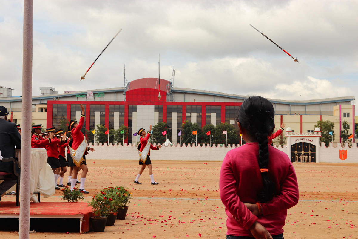 A girl watches a contingent from a school perform during the Independence Day parade at Field Marshal Manekshaw Parade grounds in Bengaluru on August 15, 2019.