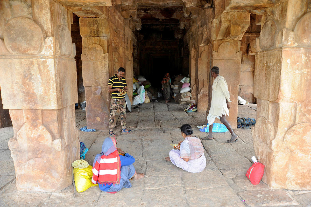 Villagers at the Sangamesvara temple in Pattadakal take shelter as their houses were levelled due to the recent floods. | DH Photo: Pushkar V