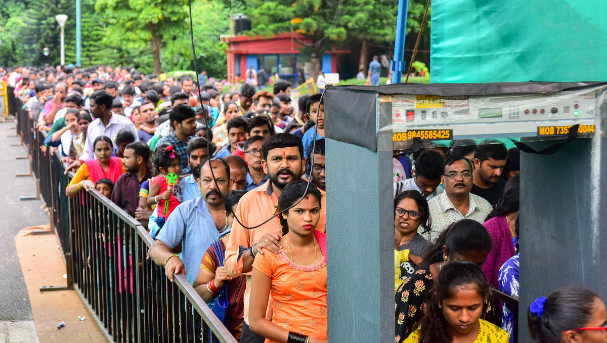 Visitors wait in a long queue to enter Lalbagh on the last day of Independence Day flow show in Bengaluru on Sunday.