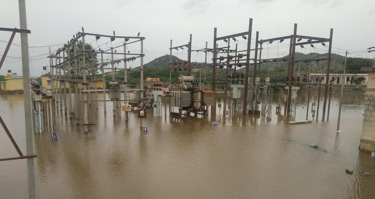 The 33kV power station flooded by rainwater in Jalahalli of Raichur district. (Right) River Hagari (Vedavathi) in spate near Raravi village of Siruguppa taluk in Ballari district, following heavy rain on Thursday. DH Photo