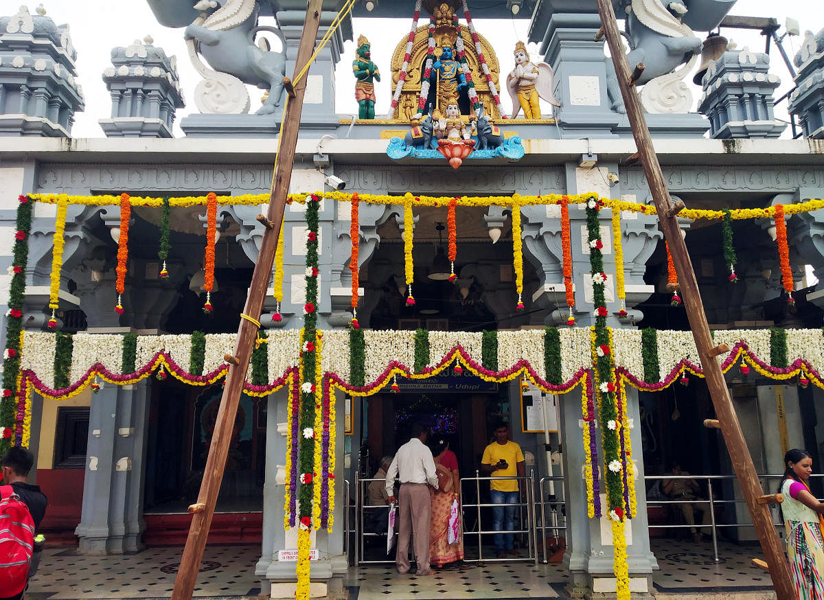 Flowers of different hues adorn the main entrance of the Krishna Mutt on the occasion of Janmashtami on Friday. (Inset) Krishna regales in the decoration of his mother Yashoda.
