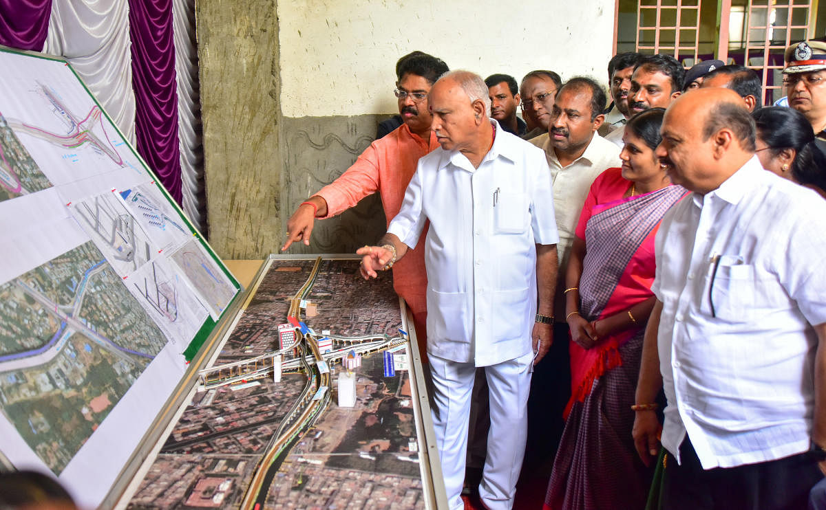 Chief Minister B S Yediyurappa and his ministerial colleagues look at a model of the Silk Board Junction metro station on Sunday. DH PHOTO/ANUP R THIPPESWAMY