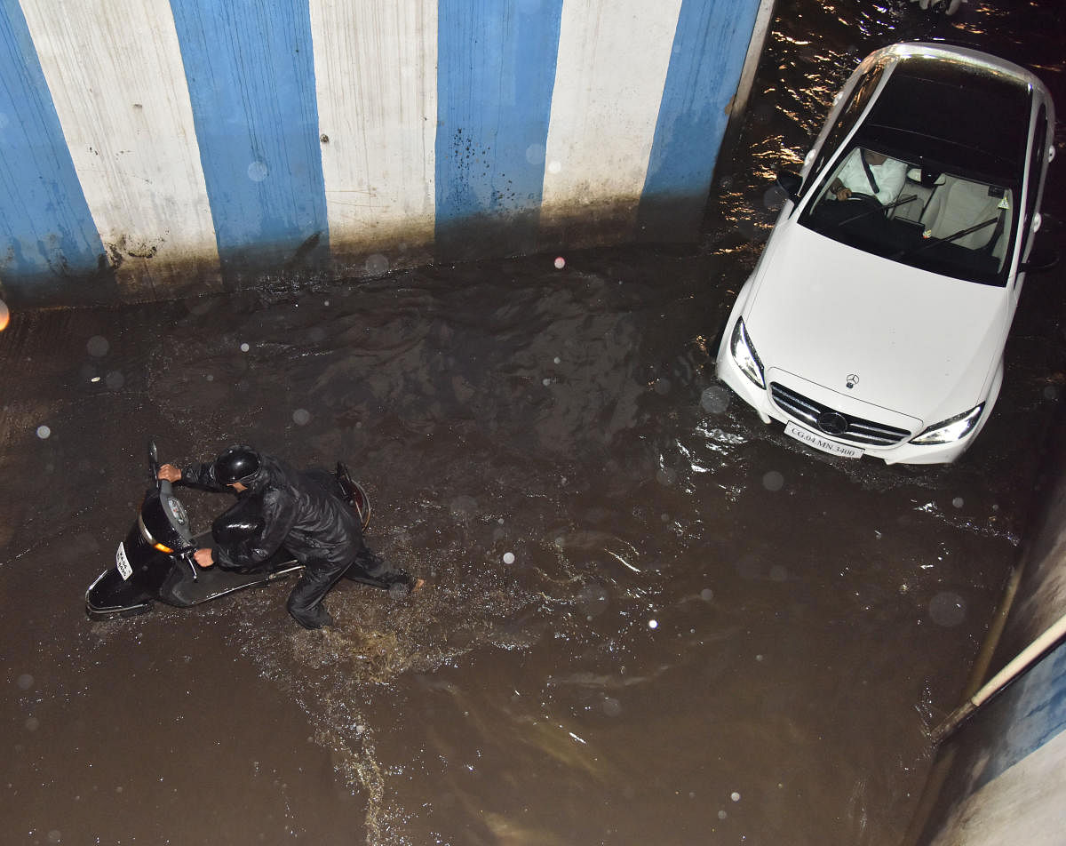 Motorists struggle to pass through the flooded Le Meridien underpass on Tuesday. DH photo/B K Janardhan 