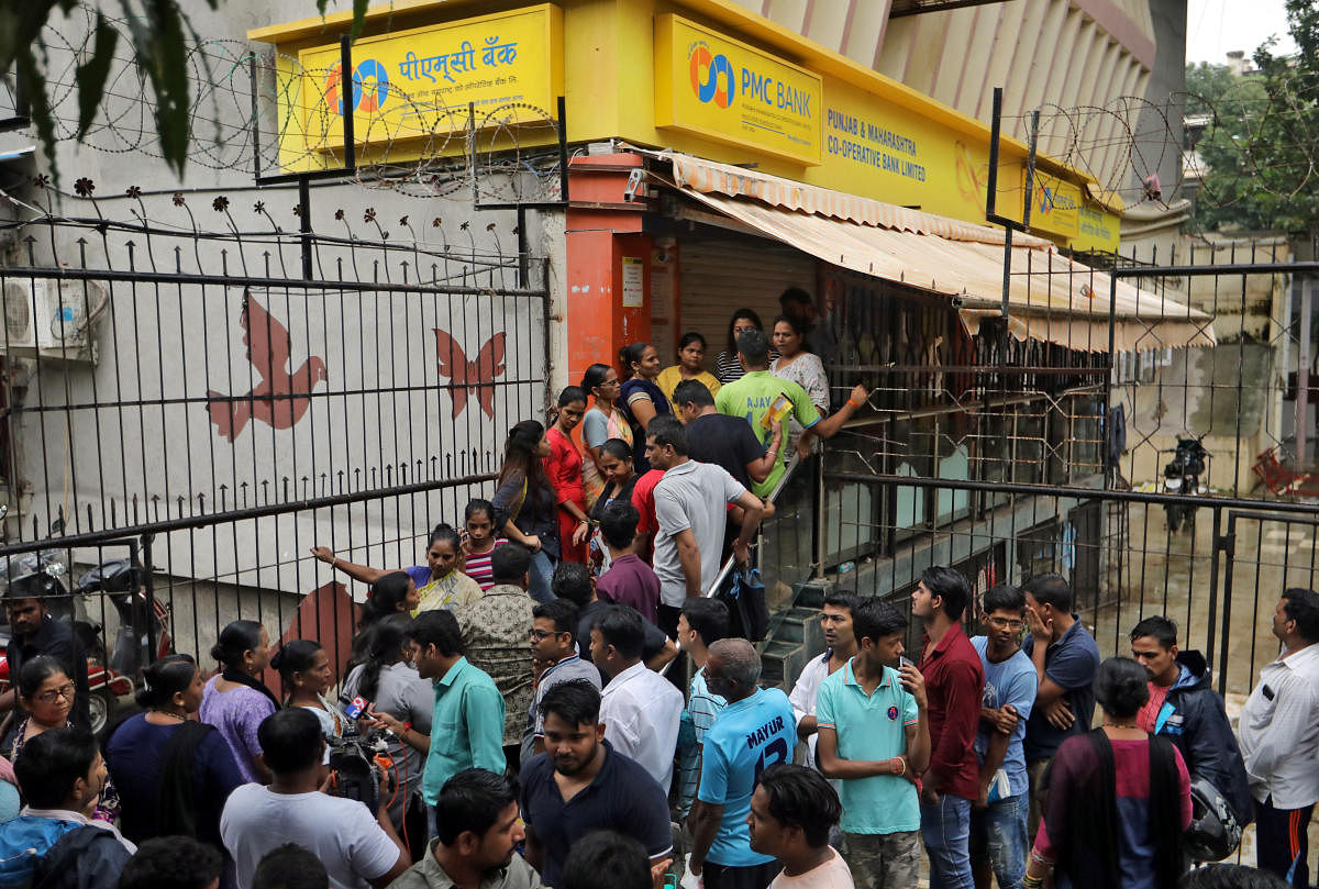 People wait outside a PMC Bank branch to withdraw their money in Mumbai. REUTERS file photo