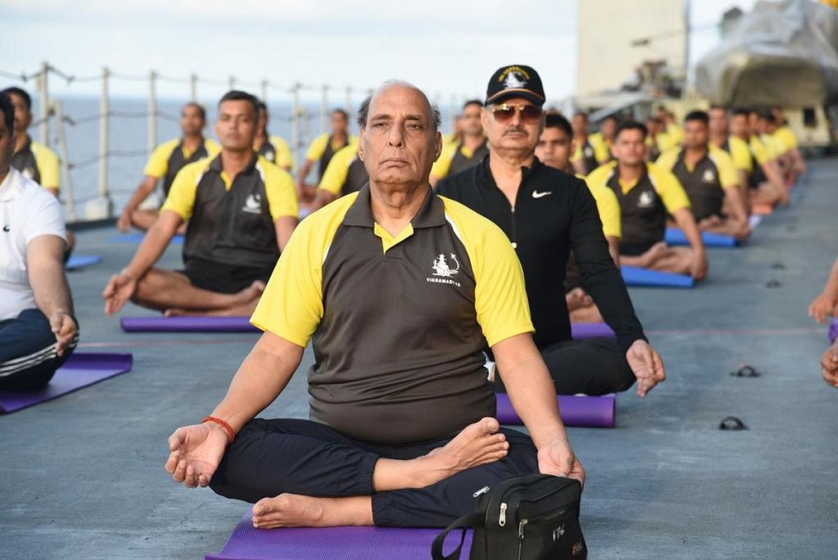 Defence Minister Rajnath Singh performs Yoga along with Navy crew.