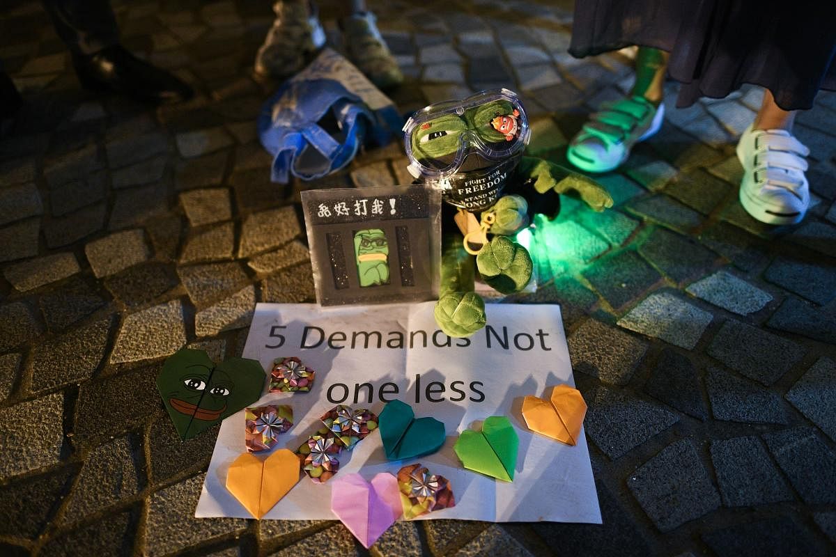 Pepe the Frog, a character used by pro-democracy activists as a symbol of their struggle, placed on the pavement by the waterfront along Victoria Harbour in Hong Kong's Tim Sha Tsui district. (Photo by AFP)