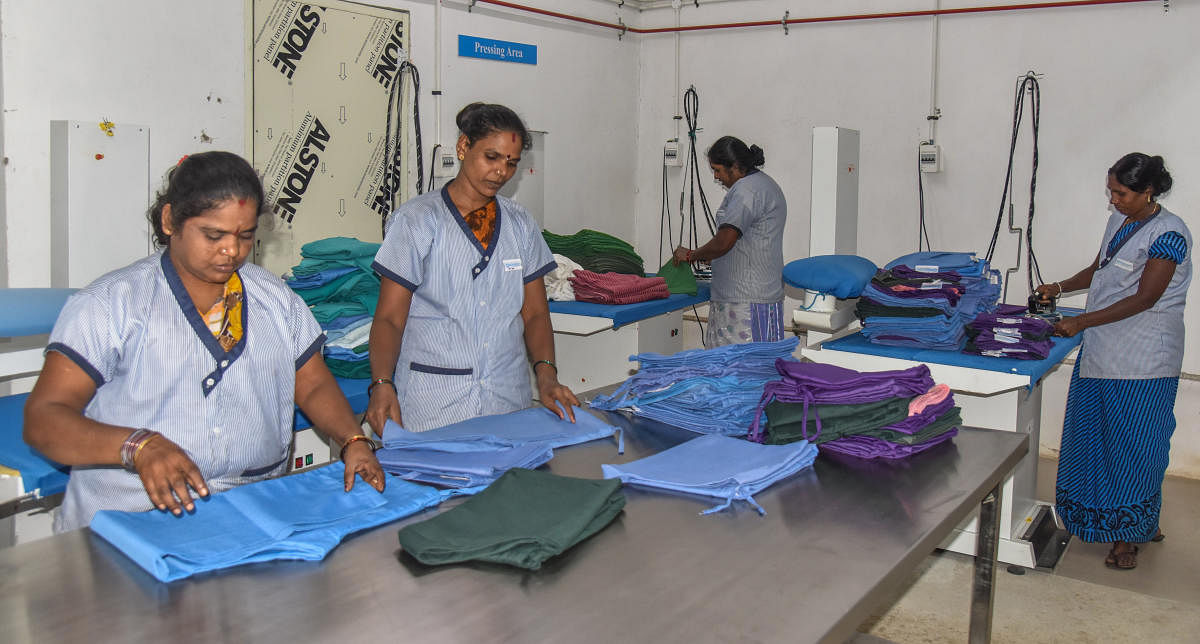 The staff at Victoria Hospital sort out cloths. DH Photo/S K Dinesh