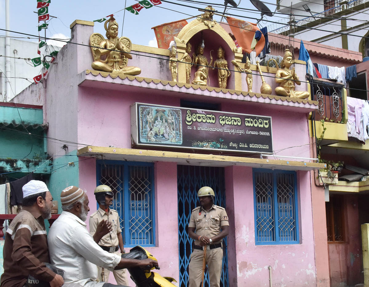 Policemen outside a Ram temple in JJ Nagar. DH PHOTO/JANARDHAN B K