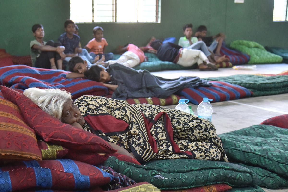 Residents at a shelter home set up by the BBMP following the flood in Hulimavu. DH PHOTO/Janardhan B K
