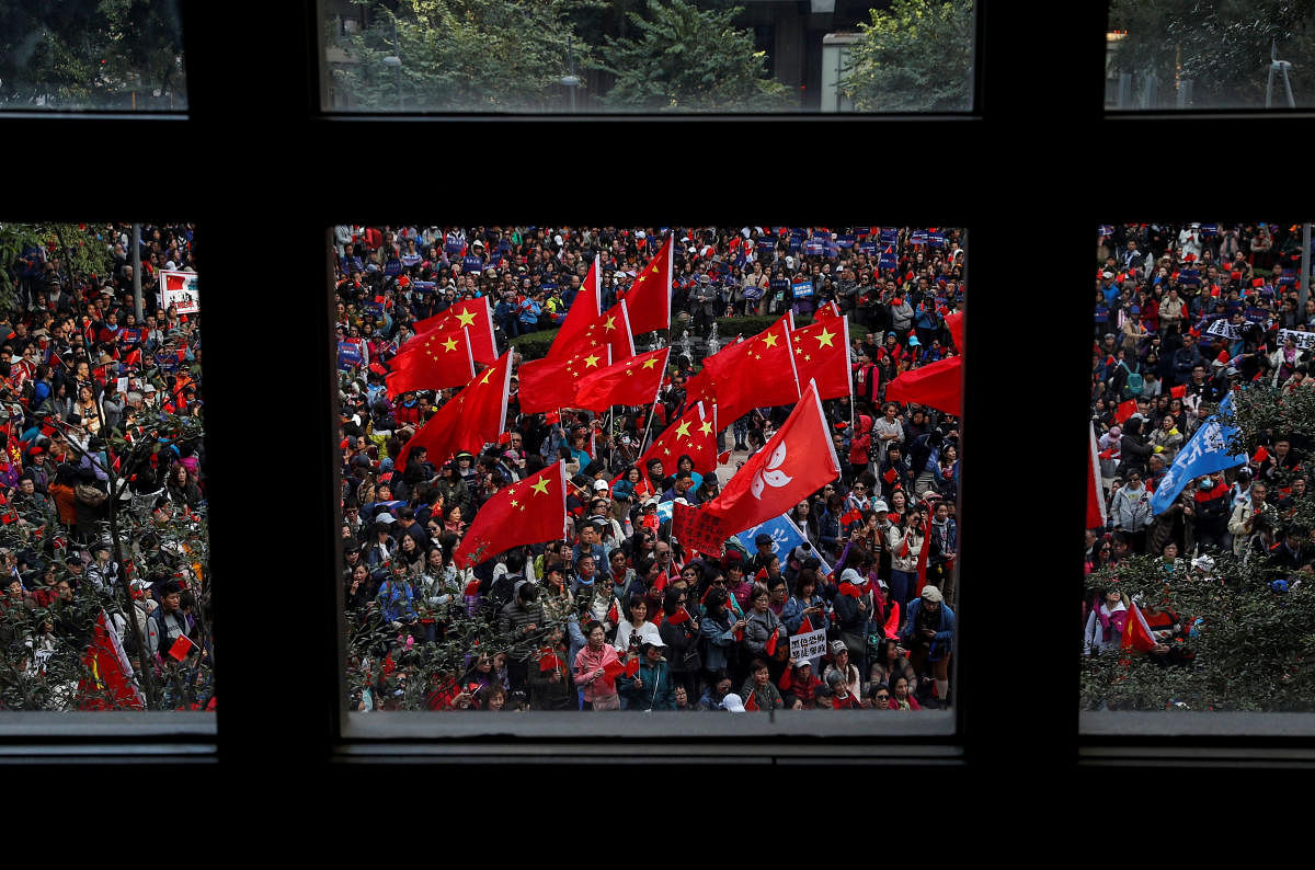 Pro-Beijing supporters wave Chinese national flags during a rally in Hong Kong, China. (Photo by Reuters)