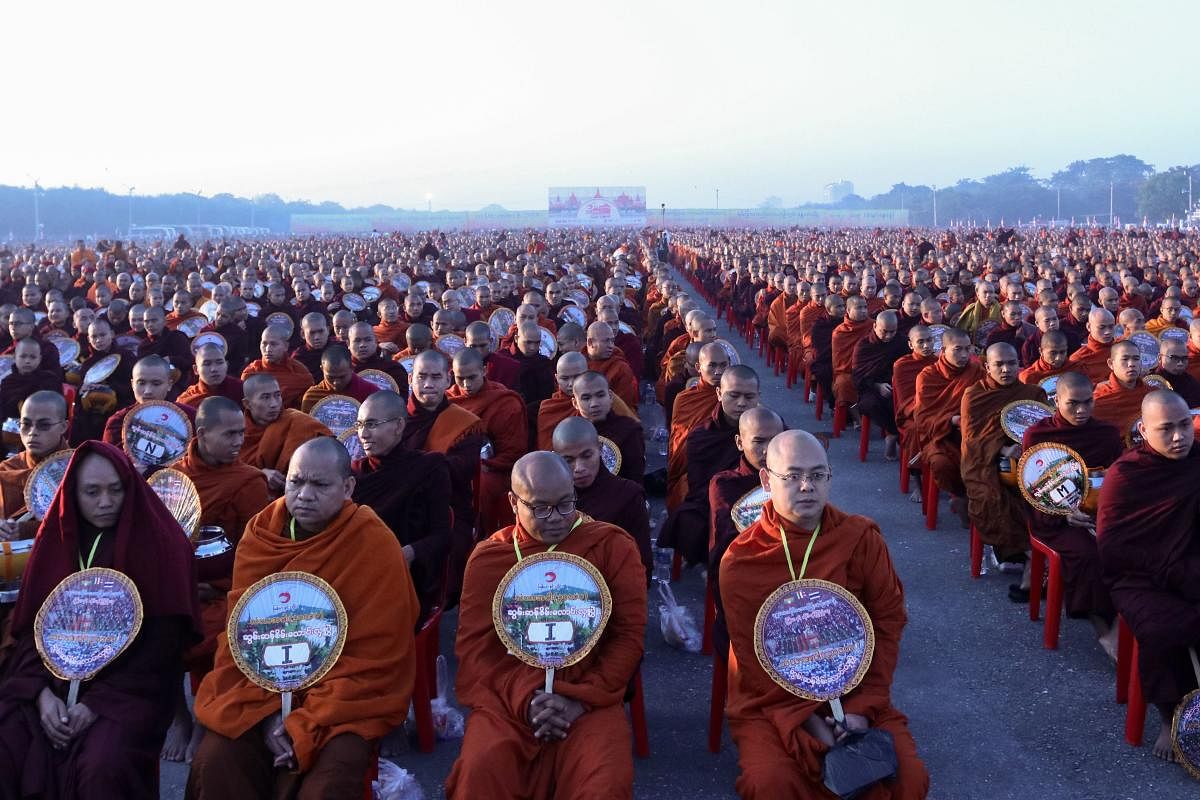 Thirty-thousand monks assembled in the early morning chill of Mandalay for a spectacular alms-giving event involving a controversial mega-temple under scrutiny across the border in Thailand. (Photo by AFP)