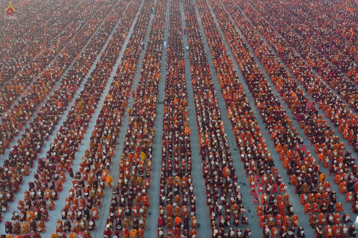 Dhammakaya Fondation shows monks lining up for alms during the alms-giving ceremony to 30,000 monks organize by the region government of Mandalay affiliated with Dhammakaya Foundation at Chanmyathazi Airport in Mandalay. (Photo by AFP)