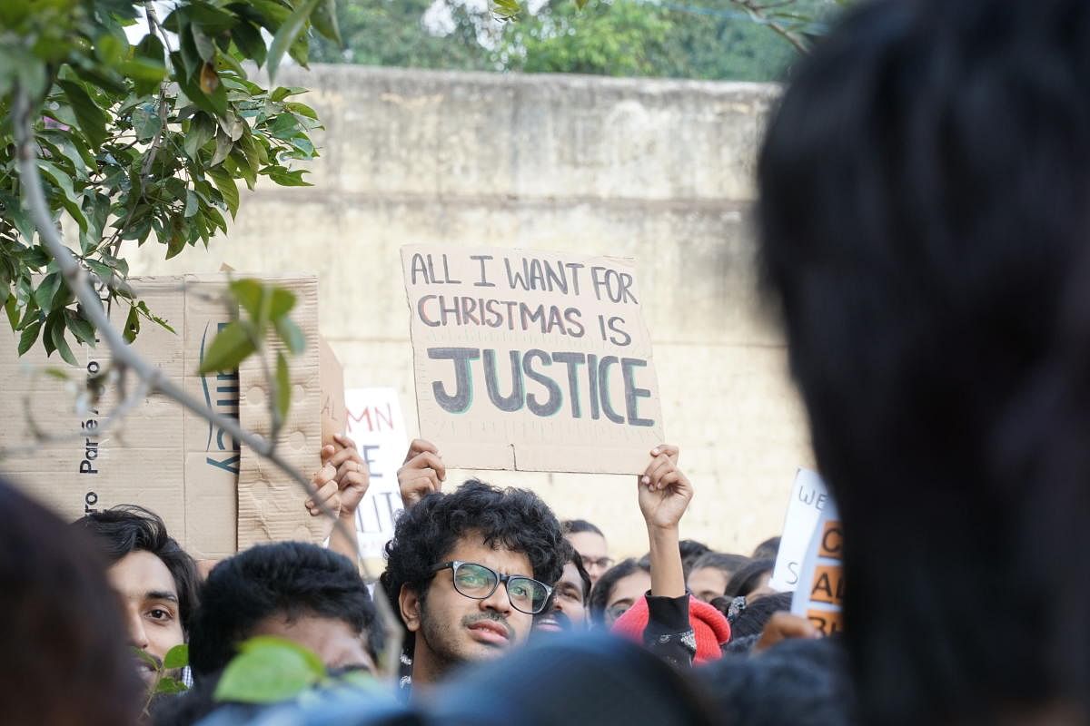 A student holds a placard in protest against the Citizenship Amendment Act and police action at Jamia at Freedom Park on Tuesday. DH PHOTO/AKHIL KADIDAL