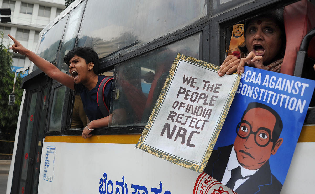 Cops detain people protesting against CAA near Town Hall in Bengaluru on Thursday. | DH Photo: Pushkar V
